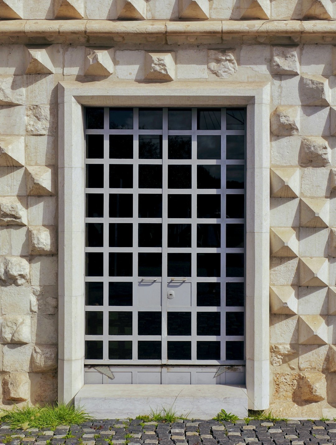 Strong metal security door in a stone wall.